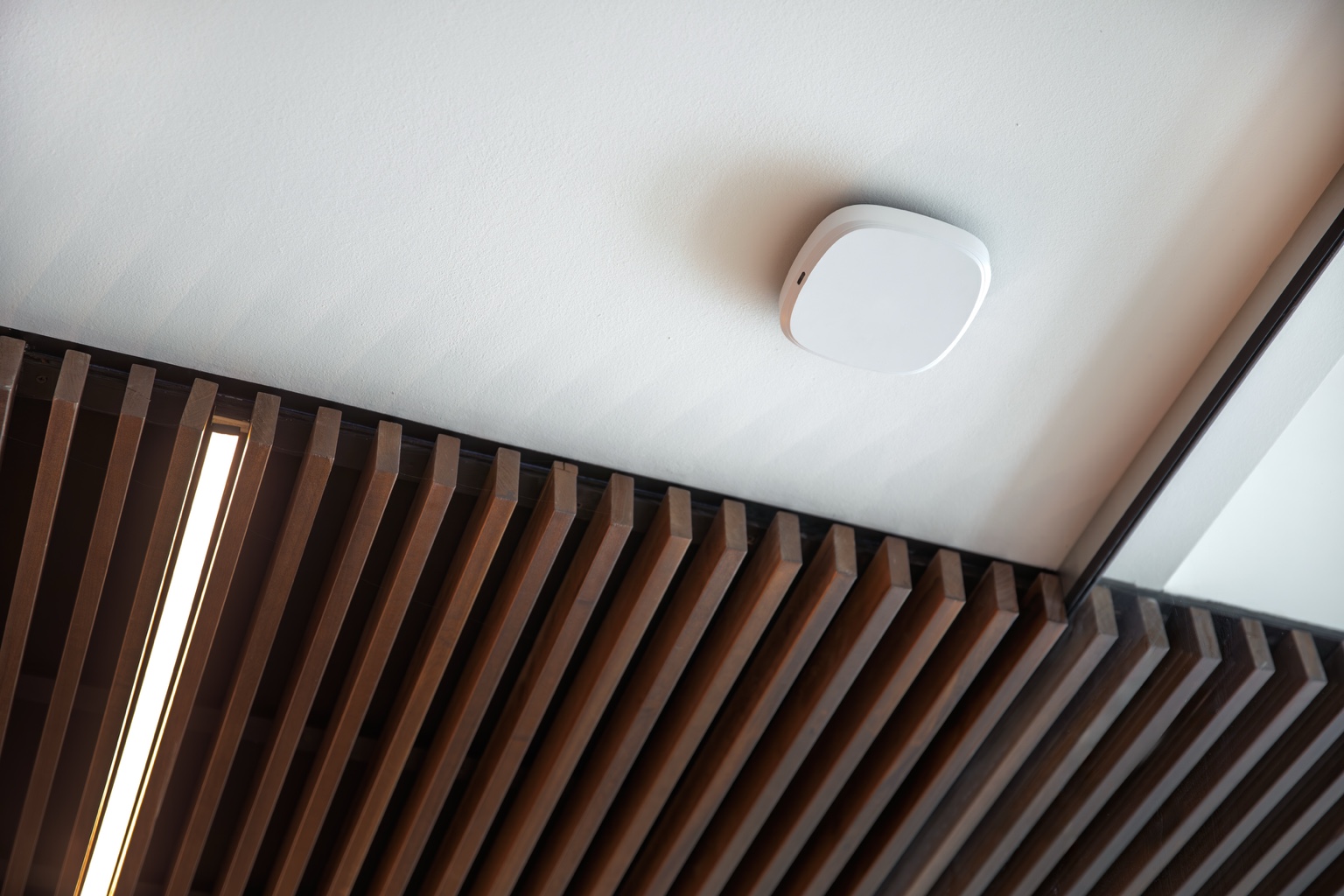 Ceiling-mounted wireless access point in a modern interior